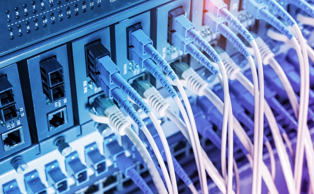 Fiber Optic cables connected to an optic ports and Network cables connected to ethernet ports.
