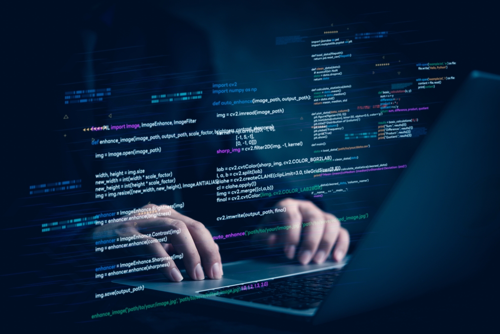 Hands typing on laptop with programming code on screen, representing software development. Perfect for coding, IT solutions, digital technology, web applications.