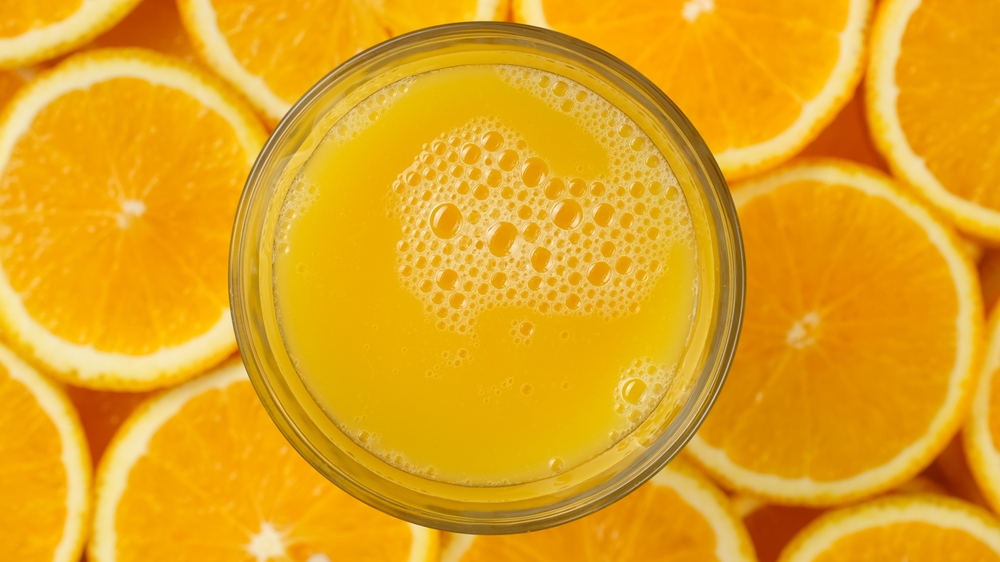 resh orange juice in glass, top view