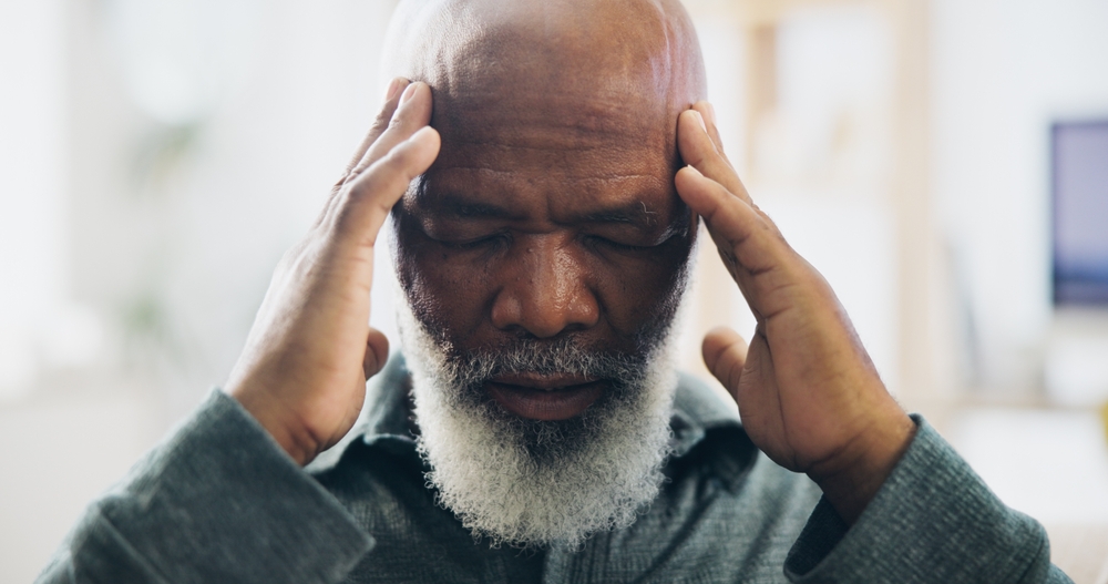 Headache, black man and senior with stress, pain and dementia problem at home. Retirement, tired and anxiety of health, medical and migraine issue with fatigue from head injury of stroke risk