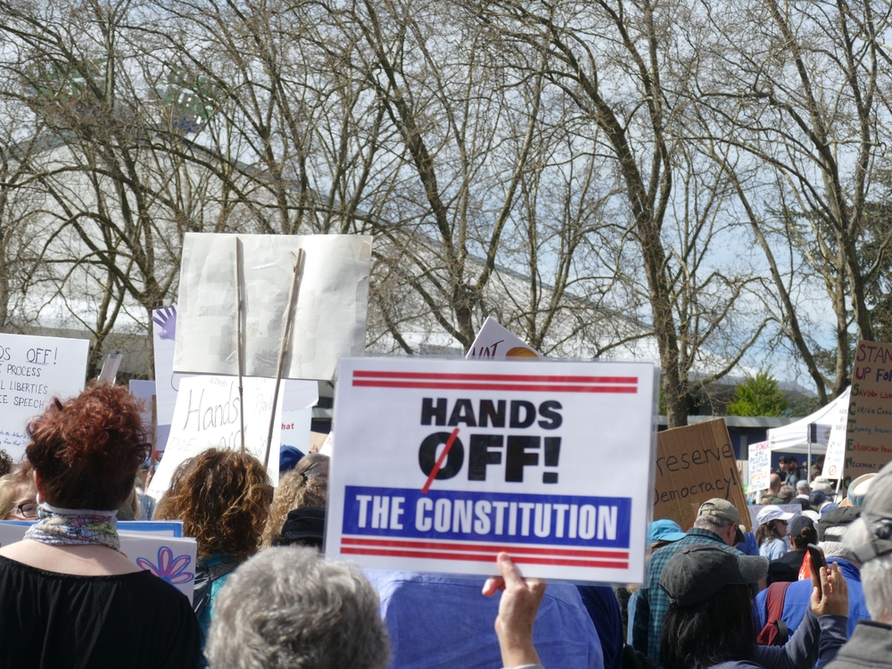 SEATTLE - APR 5, 2024 - Hands-Off anti- trump rally -- Diverse protesters rallying, holding signs defending constitutional rights and freedom of speech during peaceful civic demonstration
