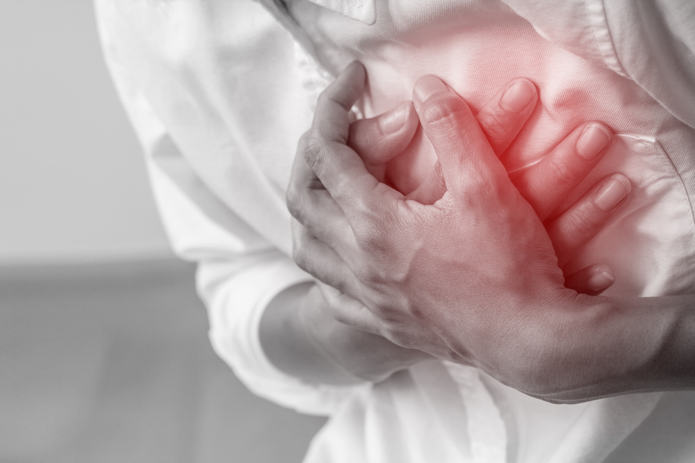 Man clutching his chest from acute pain.Heart attack symptom-Healthcare and medical concept.