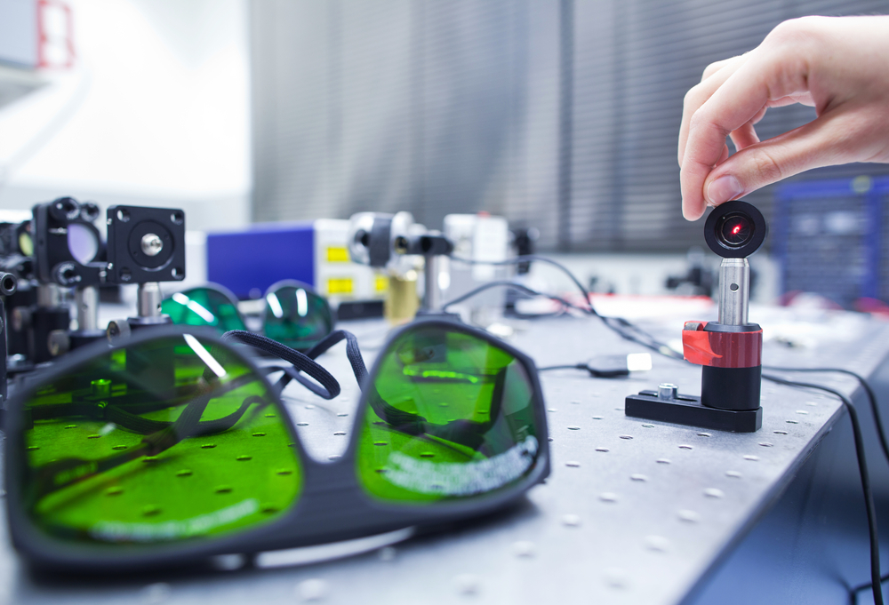 female scientist doing research in a quantum optics lab (color toned image)