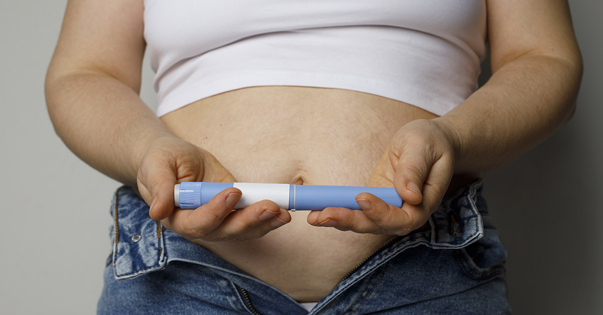 woman holding a GLP-1 drug injector
