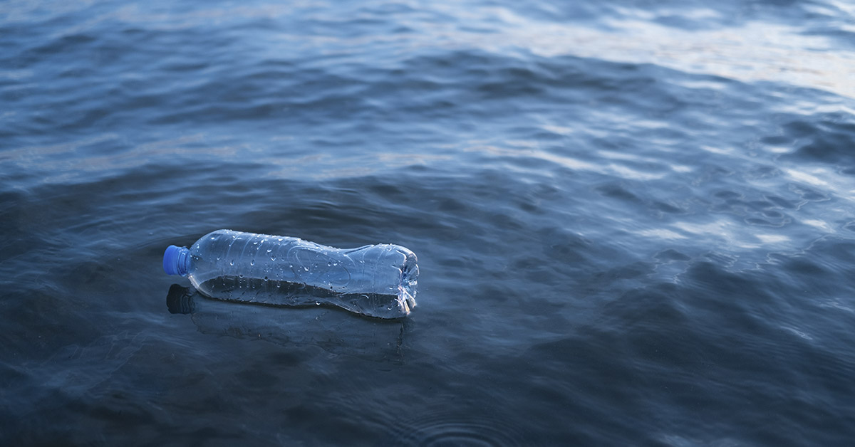 plastic bottle floating in water. Plastic pollution concept
