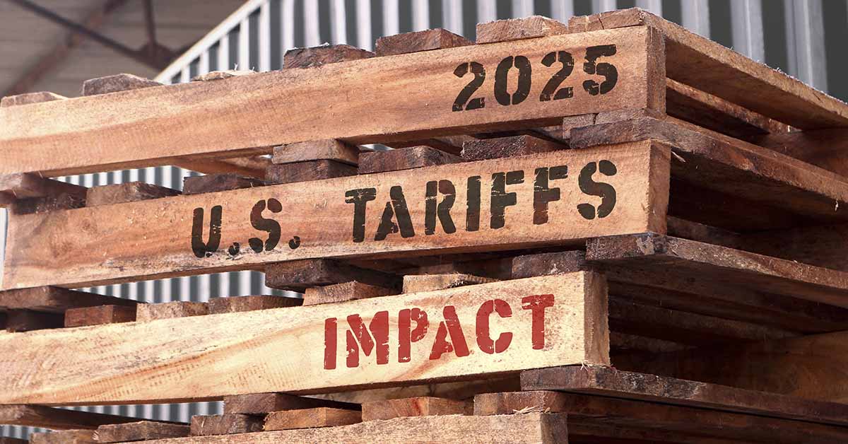 2025 Tariff Impacts written on the side of wooden pallets.