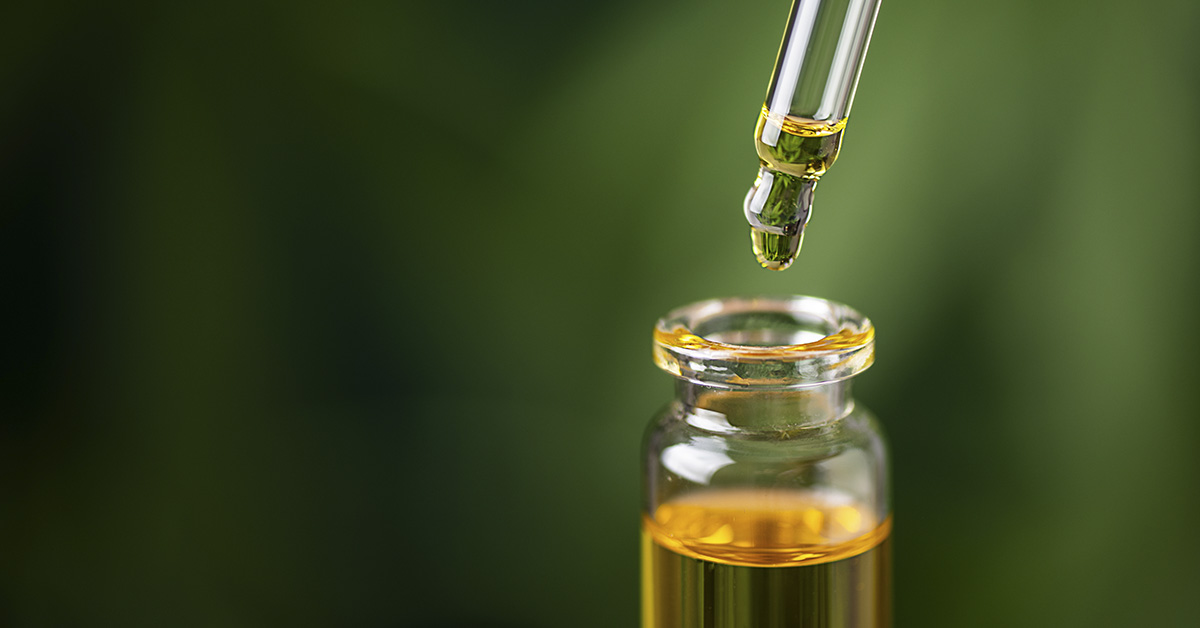 CBD hemp oil on cannabis leaf background. CBD oil extract. Medical cannabis sativa extraction. Biomedical and hemp herbal medicine