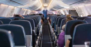 Airlines Called to Rethink Policies for Plus-Sized Passengers After Viral Photo of Man Struggling in Seat aisle on passenger jet