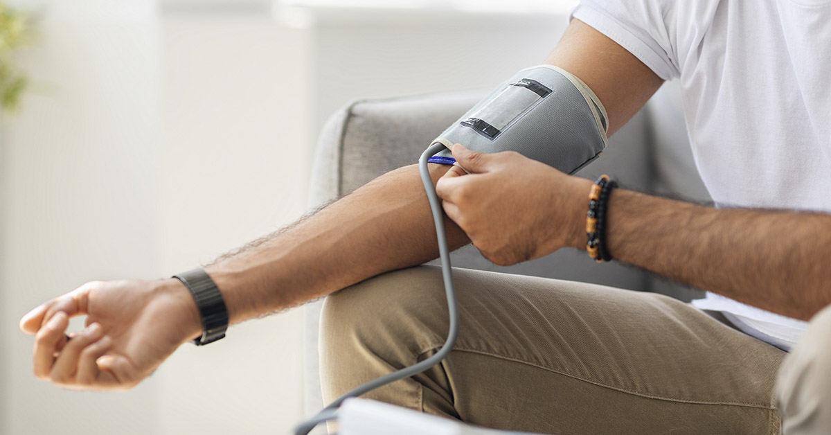 person using a blood pressure cuff