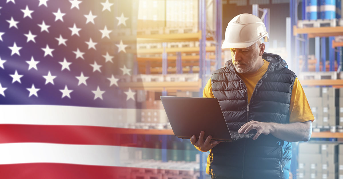 American Flag and construction worker using laptop