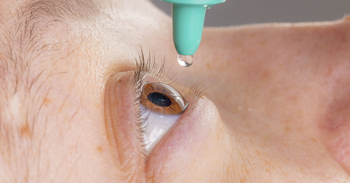 close up, man administering eye drops