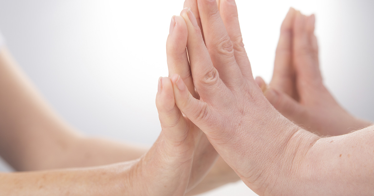 Mothers hands touching a baby's hands