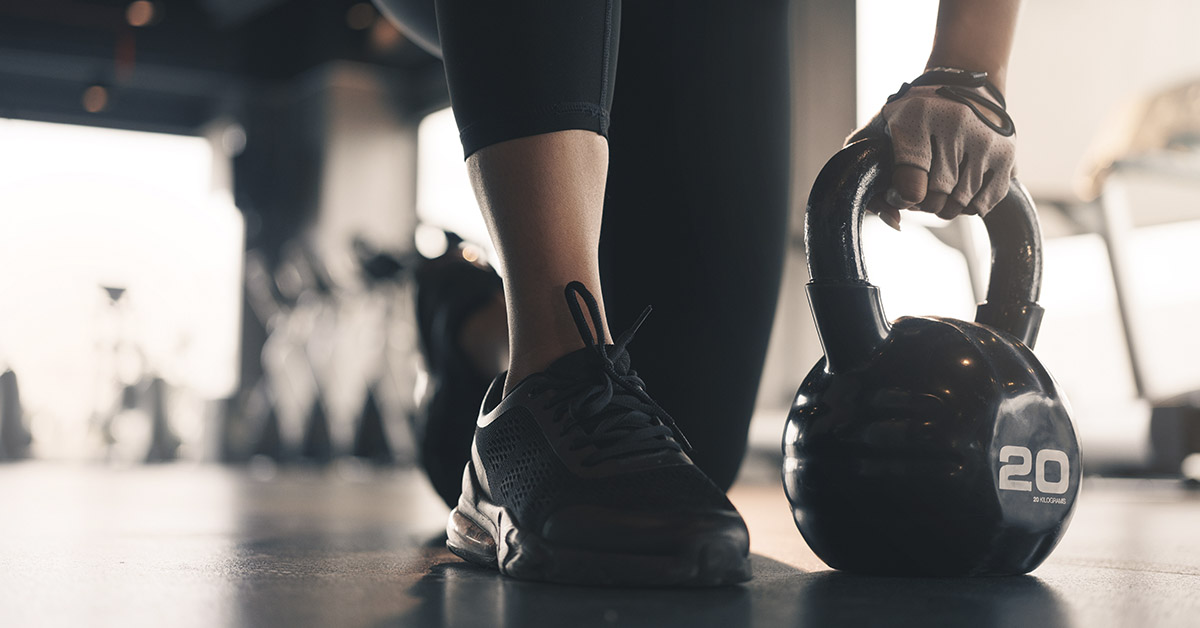 person lifting a kettle bell. Build muscle concept