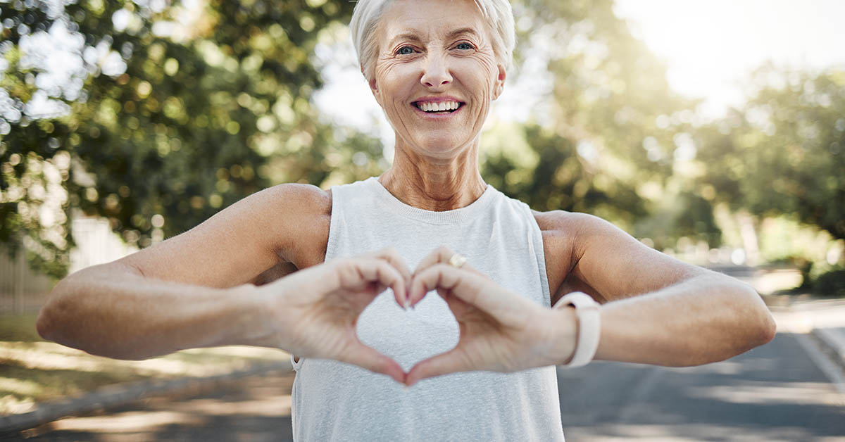 woman making the shape of a heart with her hands. Heart health concept