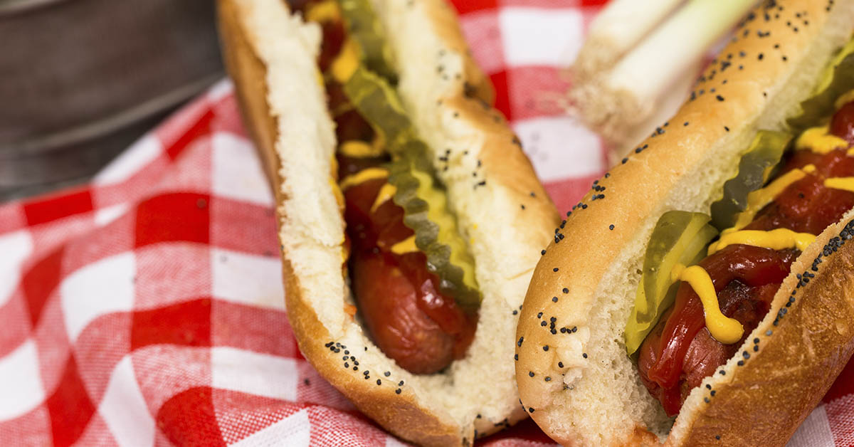 two hot dogs on red and white checkered matt
