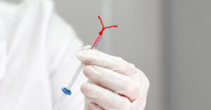 medical professional holding an IUD