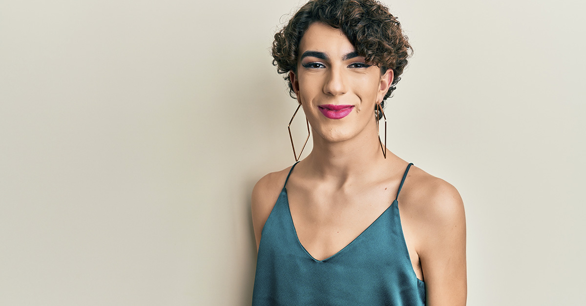 Trans woman wearing a green/blue cocktail dress
