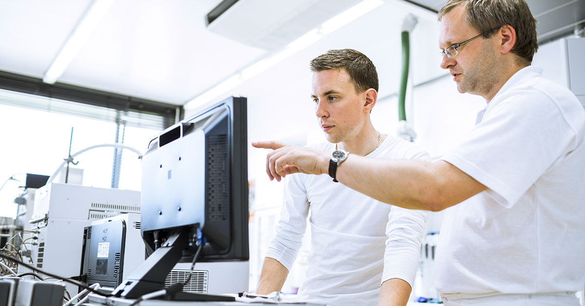 scientists using discussing in front of computer screen