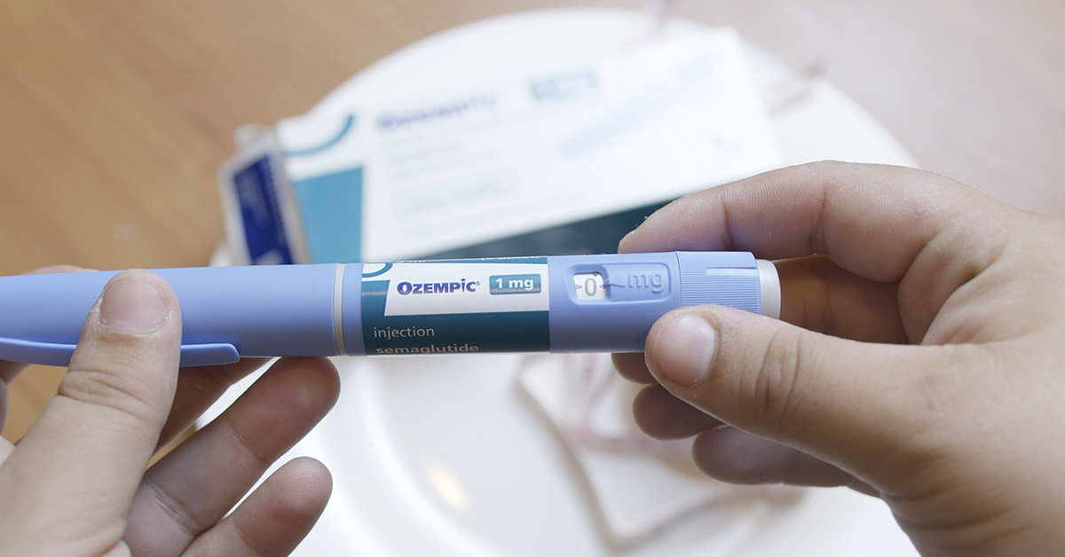 person holding Ozempic pen
