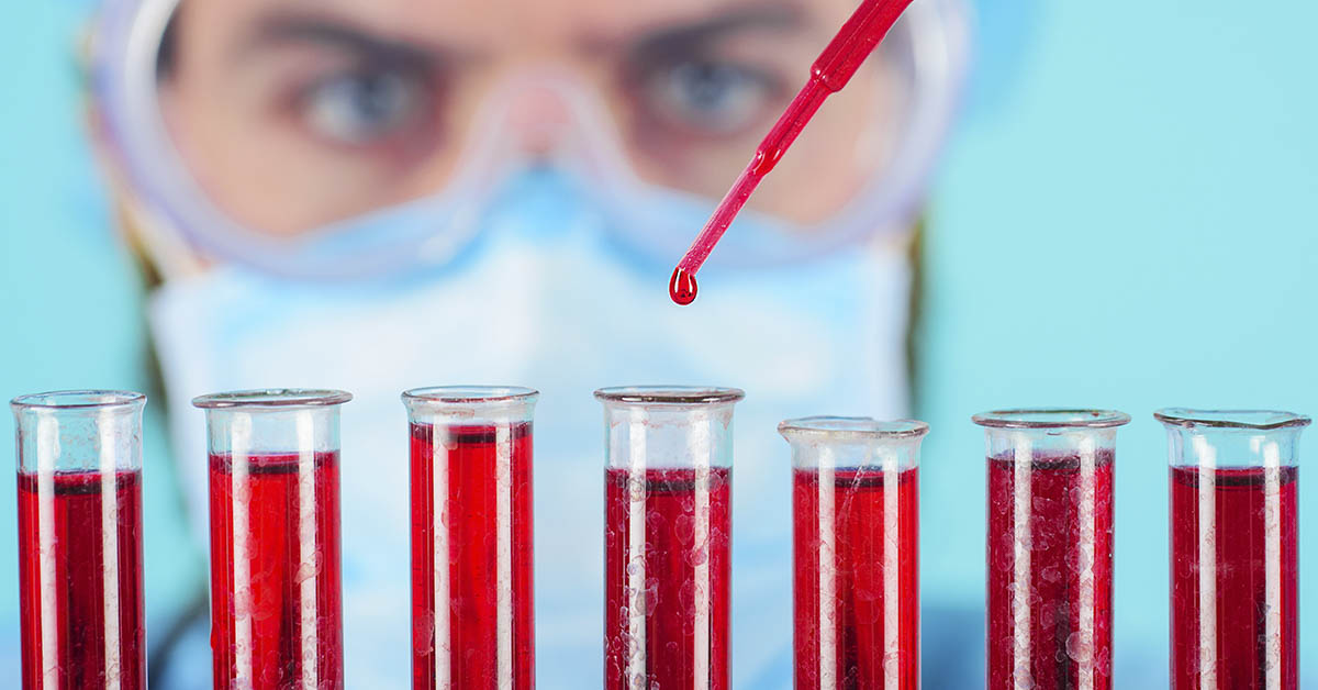Blood test. Doctor working with patient's blood sample in lab. Detection of antibodies. Serological testing in hospital. Medical scientist in mask and goggles analyzing blood sample in test tubes