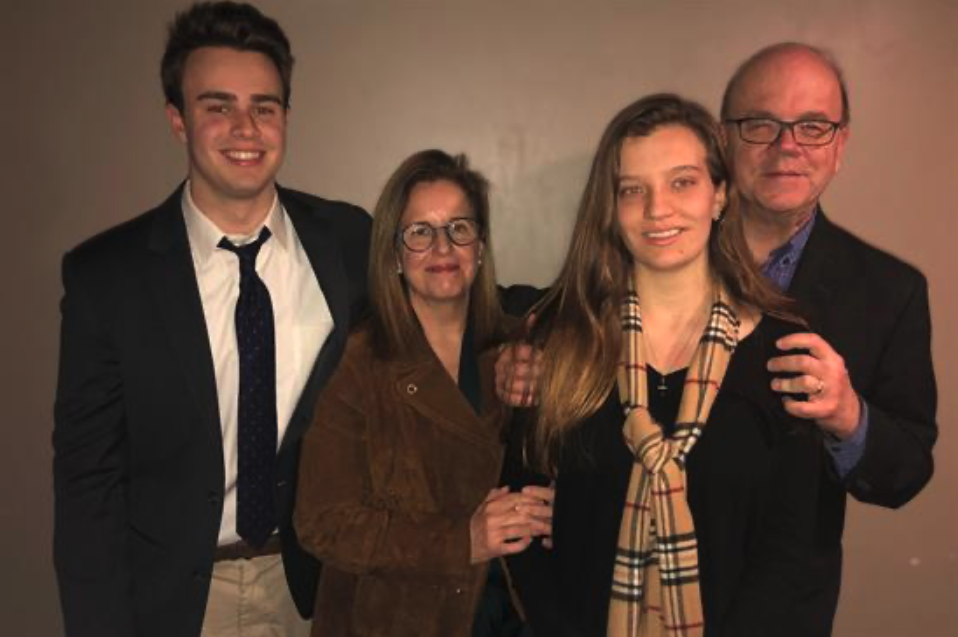 The McGovern family posing together for a formal portrait against a neutral background. Patrick McGovern stands on the left in a suit with a tie, while Lisa McGovern with glasses and brown hair wearing a brown jacket stands next to him. On the right is Molly McGovern with long light brown hair wearing a black top with a plaid scarf, standing beside Rep. McGovern in glasses and a dark jacket. The close-knit family that Rep. McGovern described as being 'cozy like puppies' shared a special bond, as mentioned following Molly's passing at age 23.