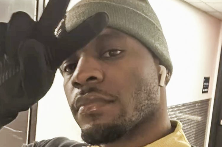 Charles Rogers taking a selfie while making a peace sign with his fingers.