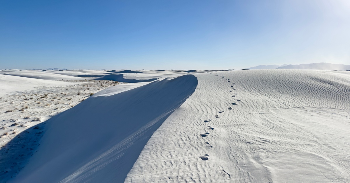 Foot steps along a cliffside in White Sands National Park. Solo traveler path in the desert of New Mexico.