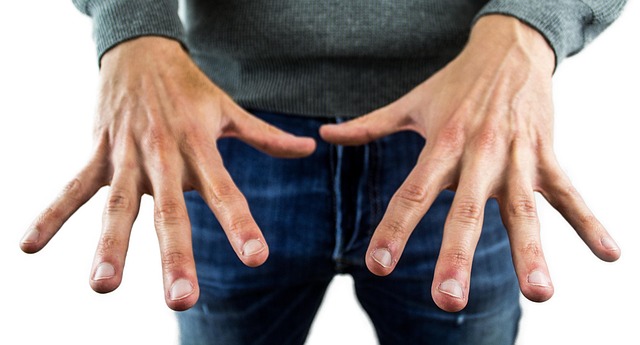 man holding hands out. Tremors as a Parkinson's disease symptom
