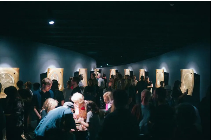 Curved brass plates surround visitors to "Revivification