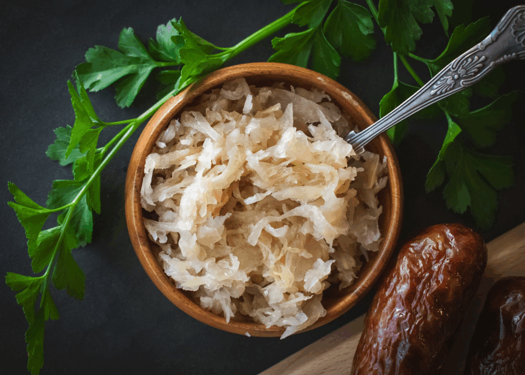 Bowl of shredded sauerkraut with parsley and dates, feeds good gut bacteria that help create mood-regulating chemicals in the brain.