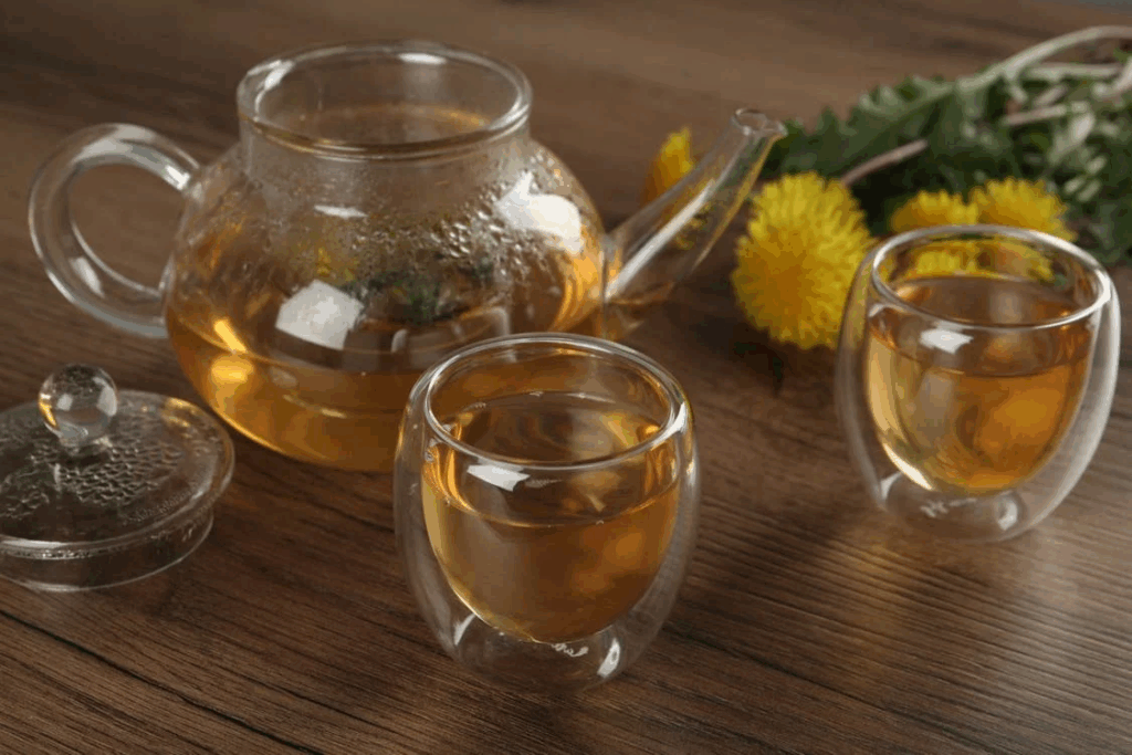 Close-Up Shot of Glasses of Beverages beside a Glass Pitcher on a Wooden Surface