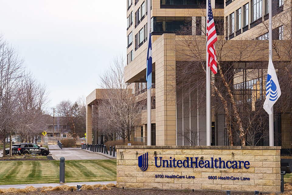 UnitedHealthcare corporate headquarters building with American flag, showing the massive scale of the nation's largest health insurer that dominates 15% of the market.
