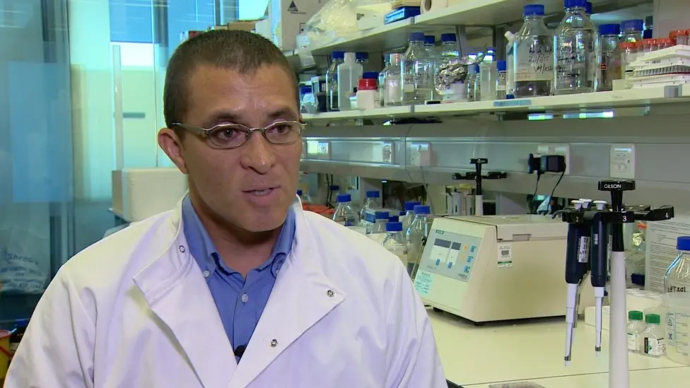 Prof. Tilo Kunath in a white lab coat working in a modern lab. He was the scientist who tested Joy's ability to smell Parkinson's disease.