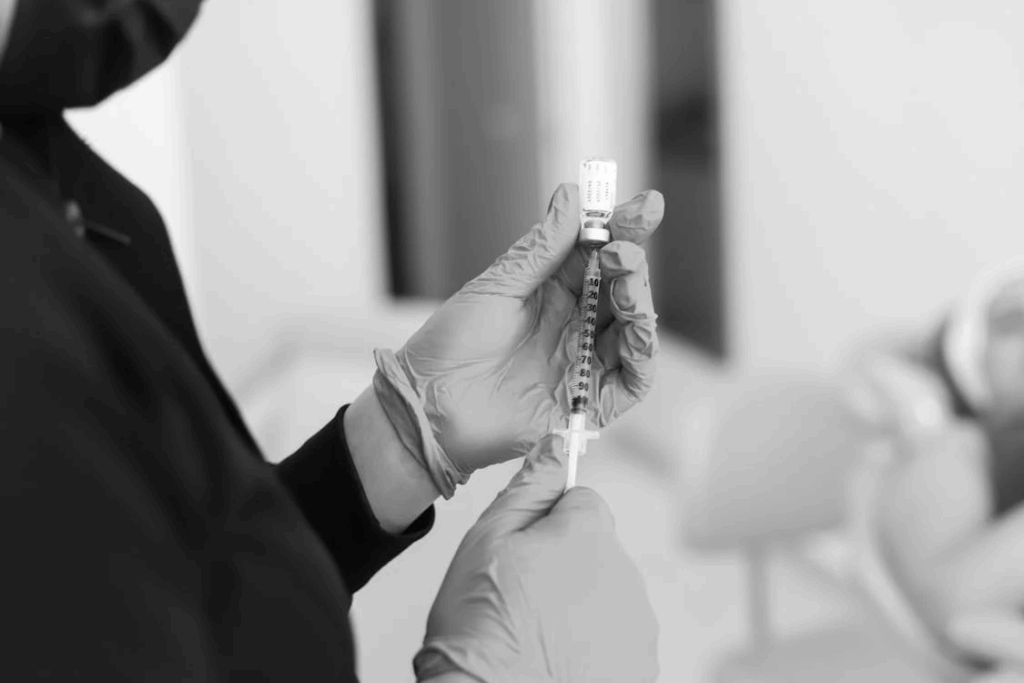 Healthcare provider preparing dermal filler injection treatment for facial restoration.
