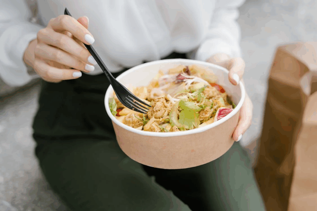 Person eating small healthy meal focused on protein and fiber for gradual weight management.