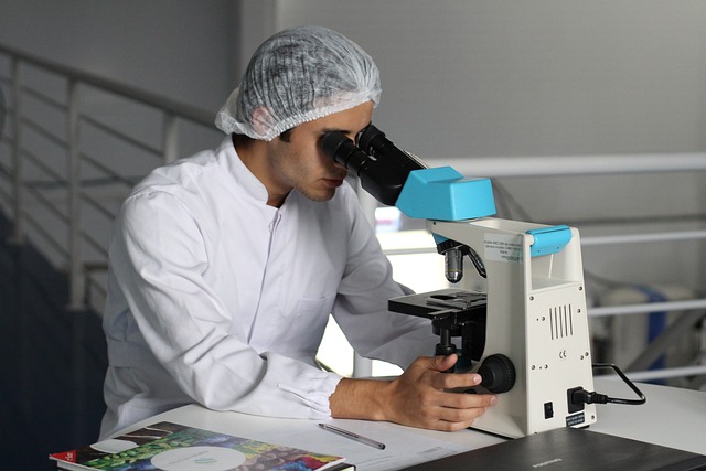 scientist looking through telescope