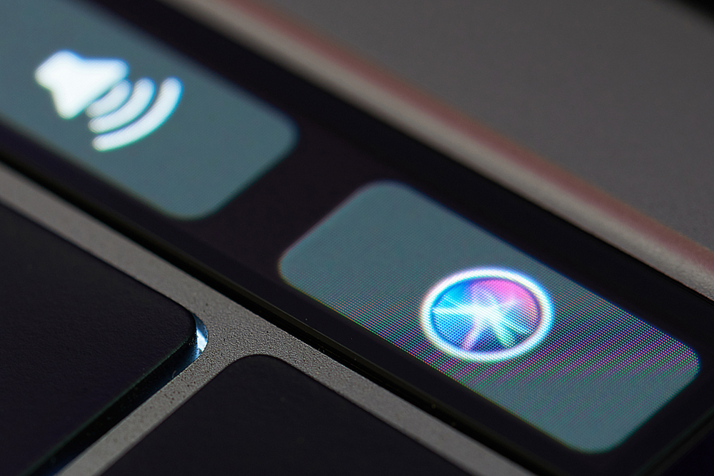 New york, USA - March 23, 2018: Siri assistant icon on touch bar of macbook latop close up