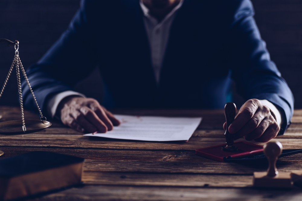 Notary public or judge reading testament. Law concept