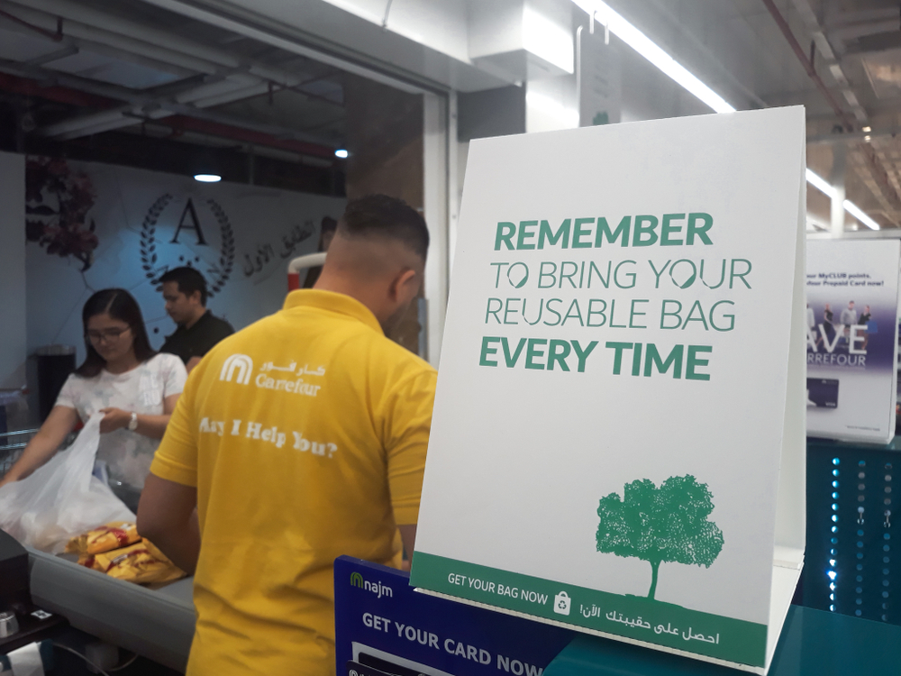 Abu dhabi, UAE - June 2019, 27. Reuseable bag reminder sign at carrefour supermarket aim to reduce the need for plastic bag that pollutes our planet