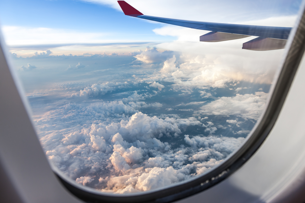 Clouds and sky as seen through window of an aircraft