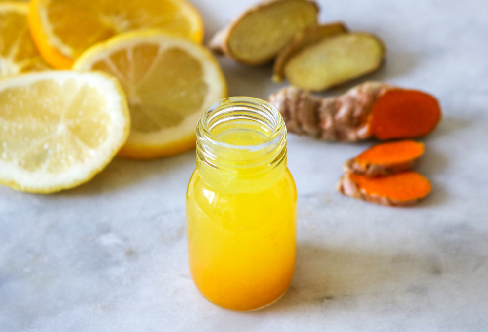 Close up of a healthy Ginger Lemon Turmeric Shot – ideal to boost the immune system during the winter.