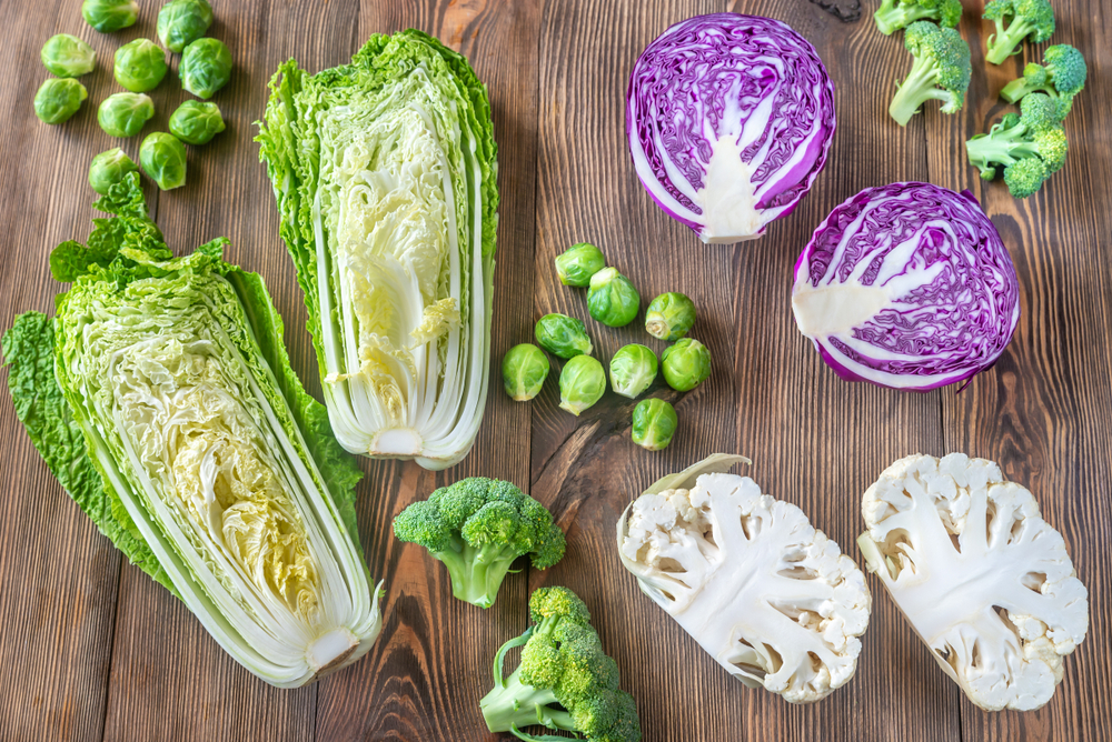 Assortment of different Cruciferous vegetables on the wooden background