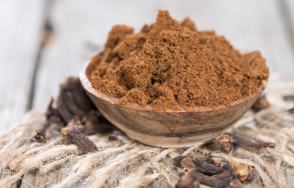 Clove Powder in a small bowl (close-up shot)