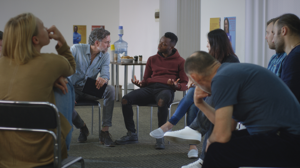 Black man talking about videogames addiction during support meeting