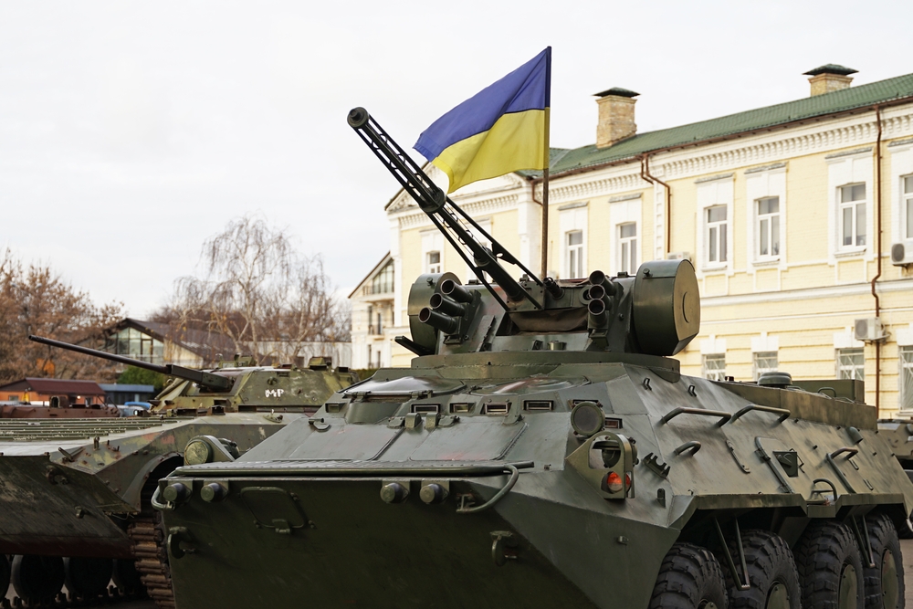 Army troops transporter and tank with Ukrainian flag, Ukraine - Russia war crisis concept, Kyiv