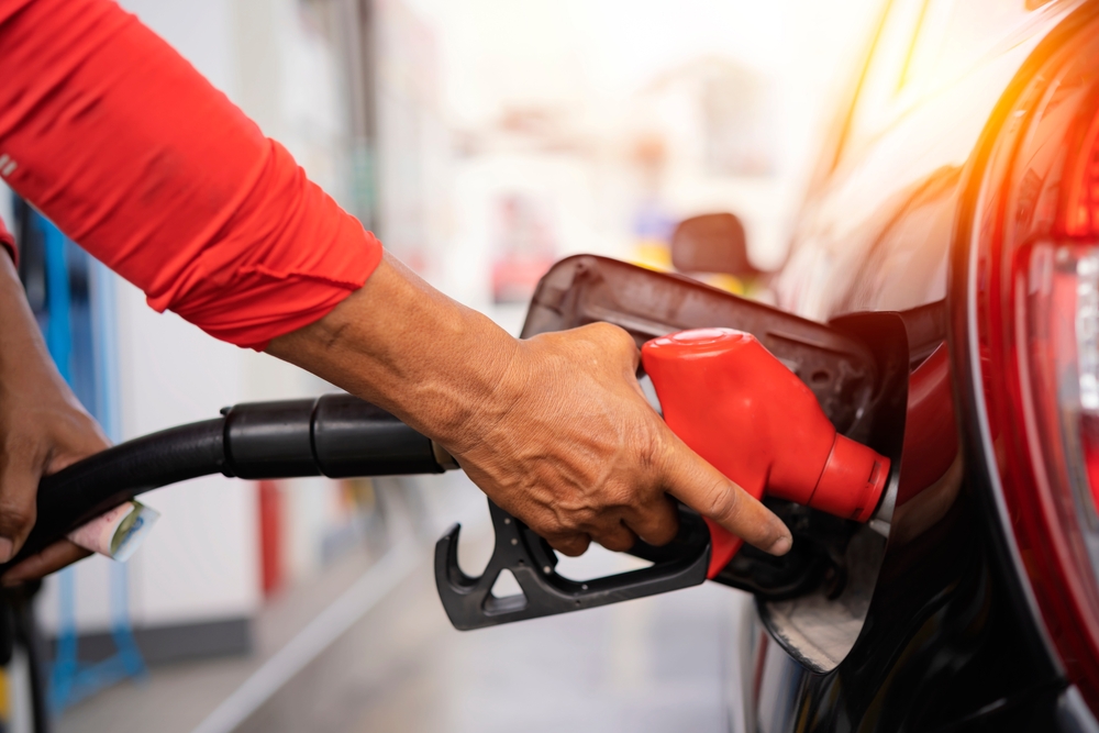 Refueling the car at a gas station fuel pump. Man driver hand refilling and pumping gasoline oil the car with fuel at he refuel station. Car refueling on petrol station. Fuel pump at station