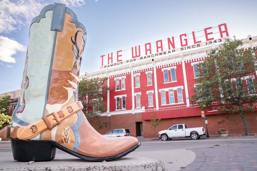 CHEYENNE, Wyoming - APRIL 27, 2018: Sign on top of The Wrangler in historic downtown Cheyenne Wyoming. The three story red-painted brick building dominates a corner of Capitol Avenue and Lincoln Way.