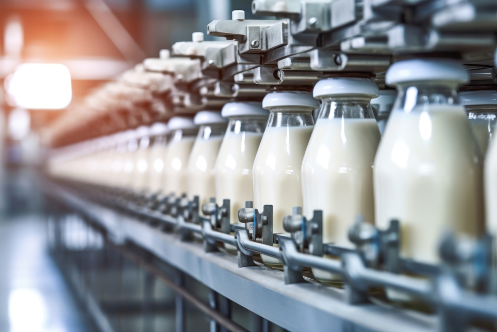 Milk factory. Robotic factory line for processing and bottling of milk. Selective focus.
