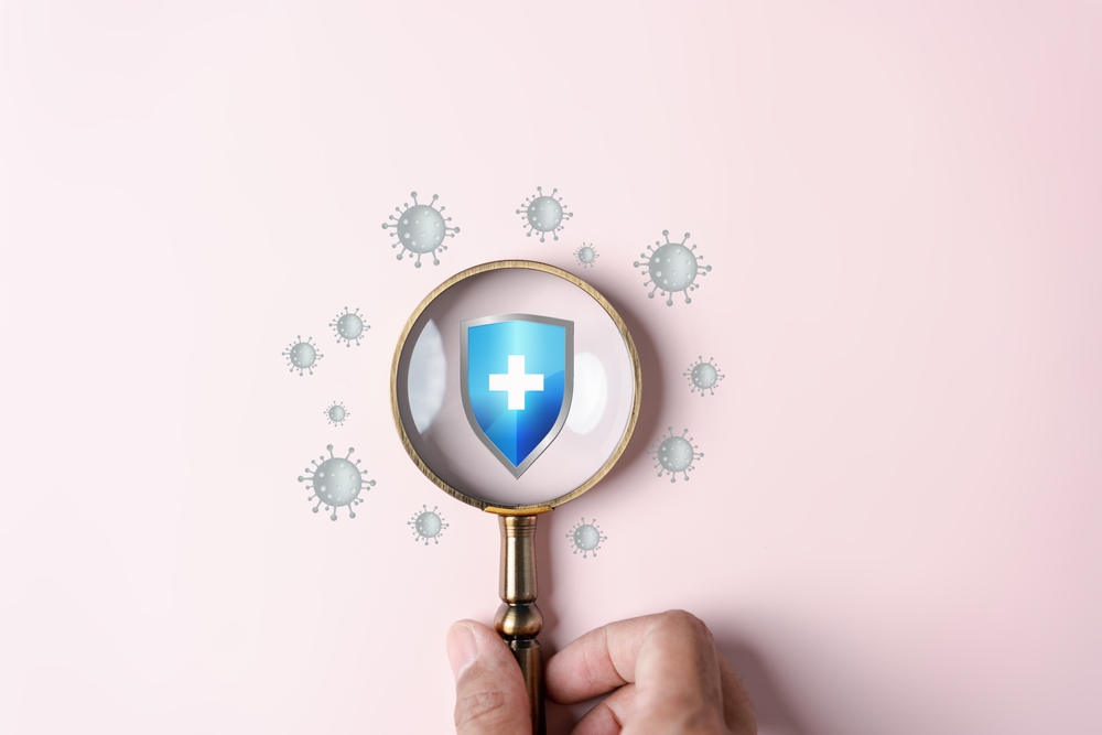 Hand holding magnifier focus to protection shield anti virus and bacteria, Health care secure concept.