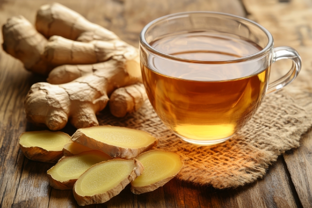 Ginger Tea with Sliced Ginger on Wooden Table